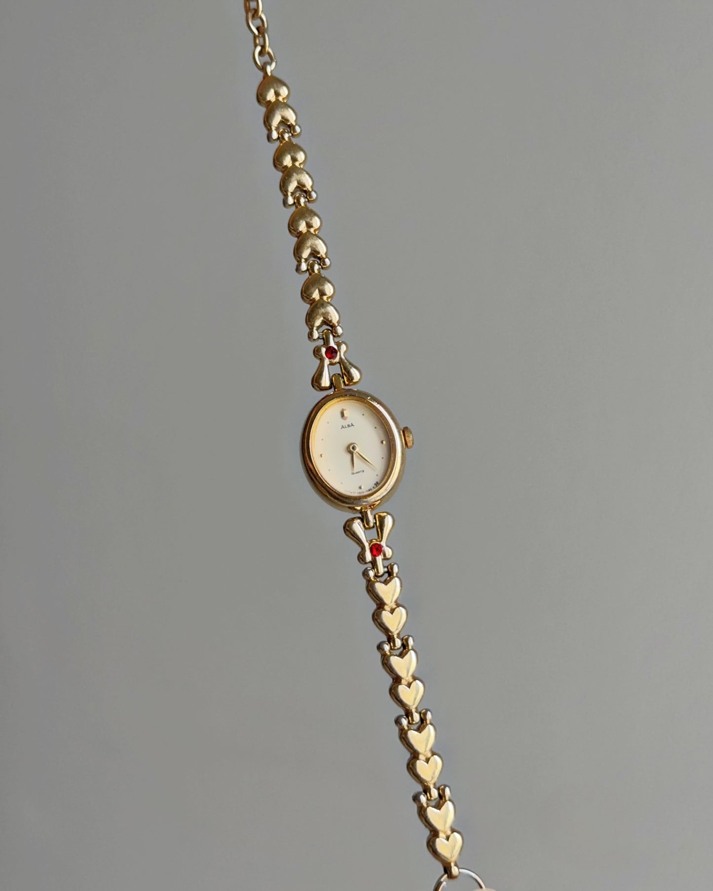 Dainty Alba Gold-Tone Bracelet Watch with Red Gem Accents