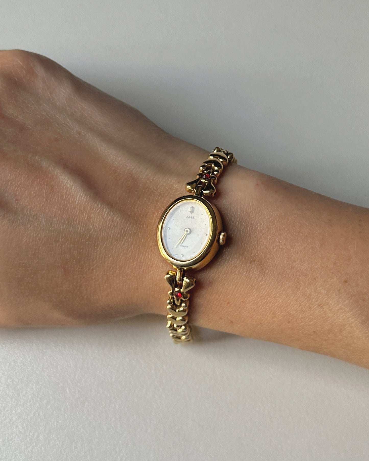 Dainty Alba Gold-Tone Bracelet Watch with Red Gem Accents