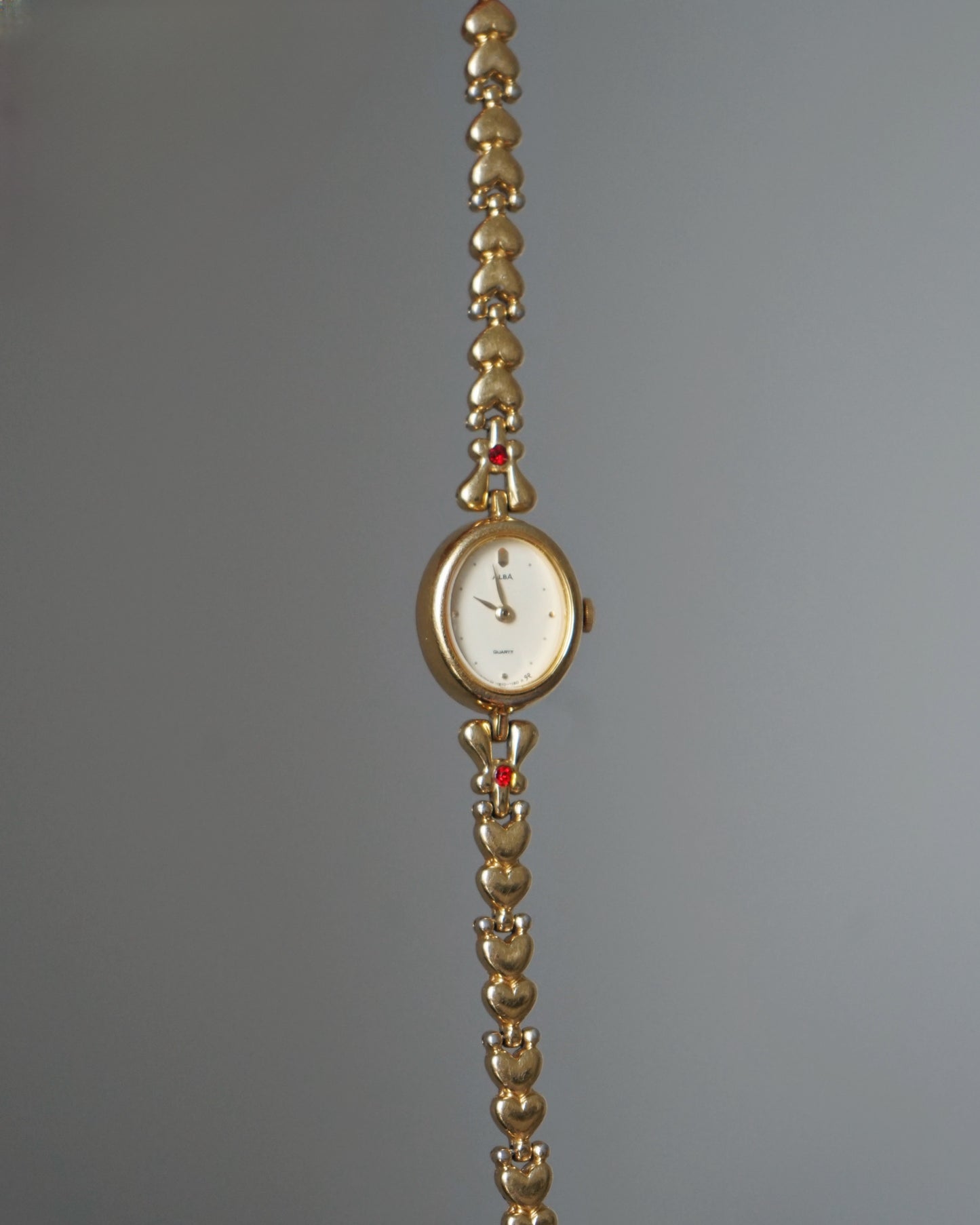 Dainty Alba Gold-Tone Bracelet Watch with Red Gem Accents
