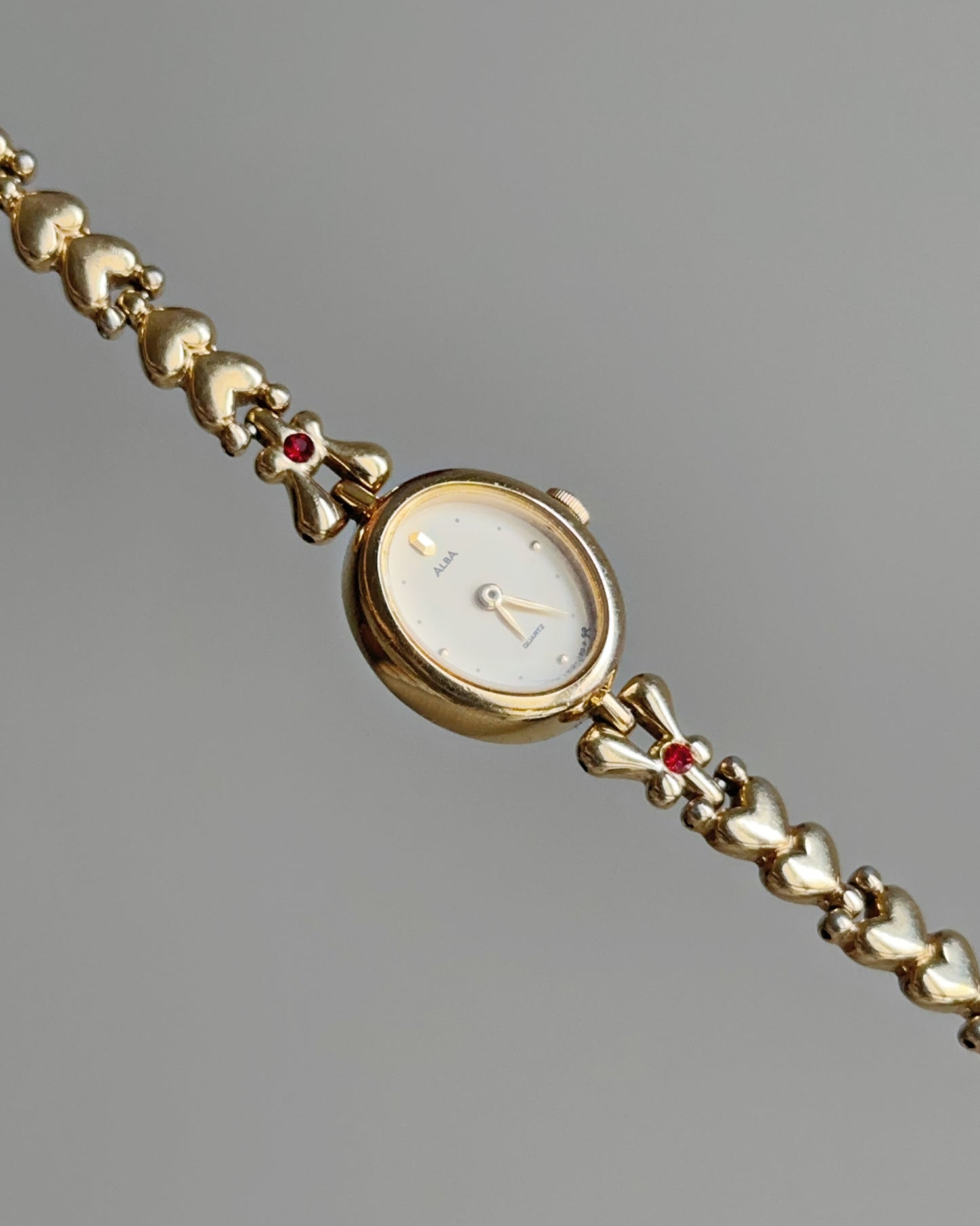 Dainty Alba Gold-Tone Bracelet Watch with Red Gem Accents