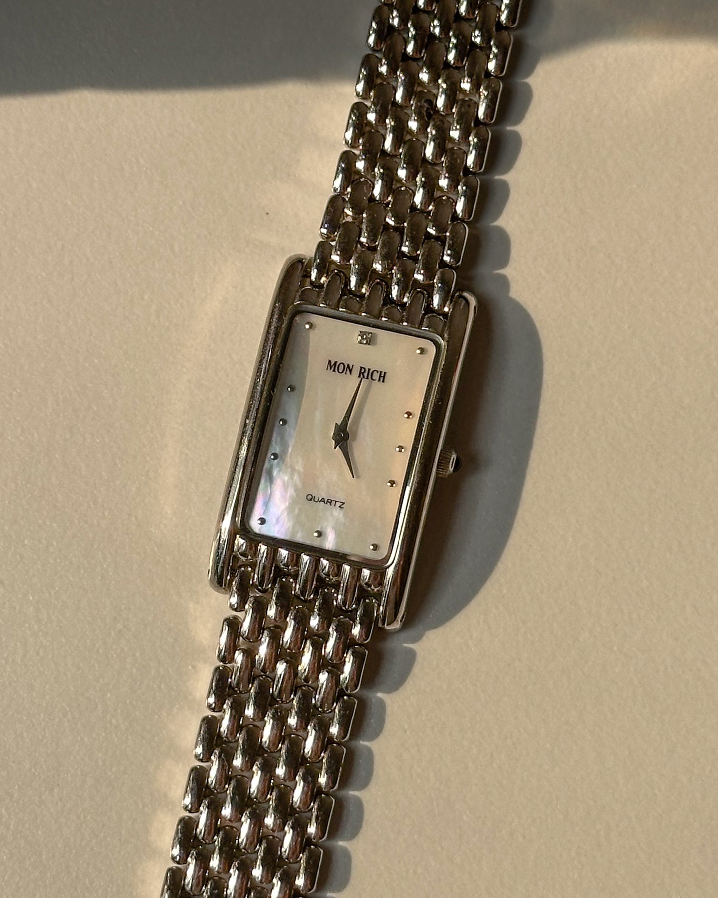 Silver tone mother of pearl tank watch